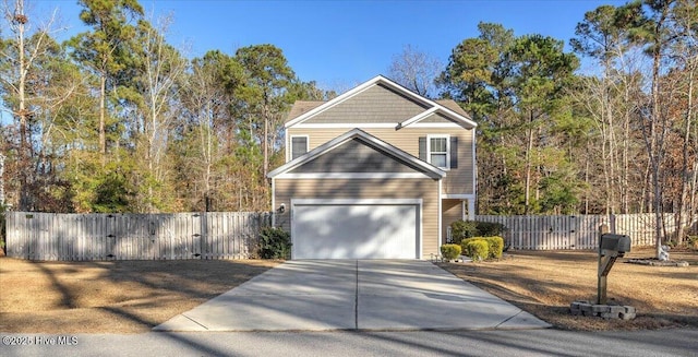 view of front of home featuring a garage, concrete driveway, and fence