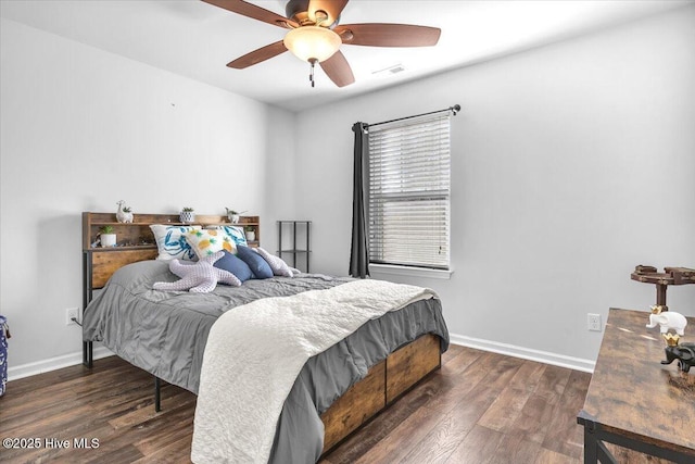 bedroom with baseboards, visible vents, ceiling fan, and wood finished floors