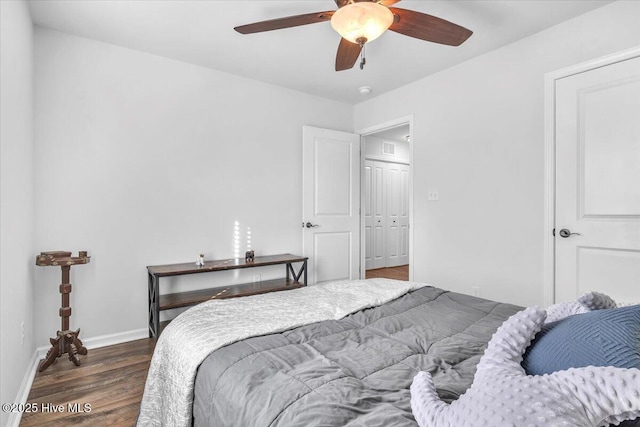 bedroom featuring wood finished floors, a ceiling fan, and baseboards