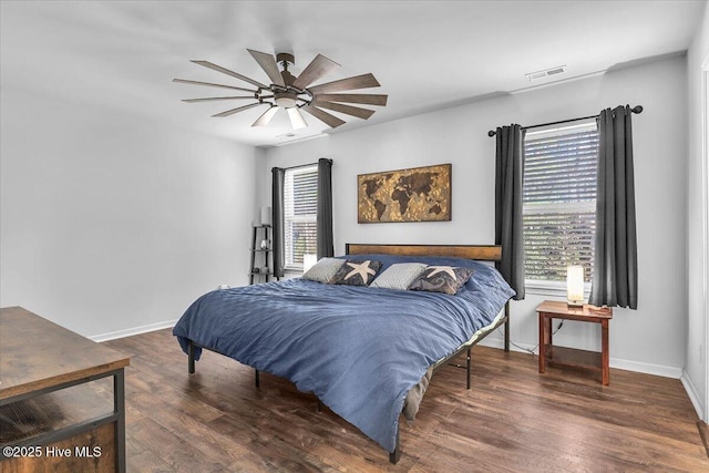 bedroom featuring ceiling fan, wood finished floors, visible vents, and baseboards