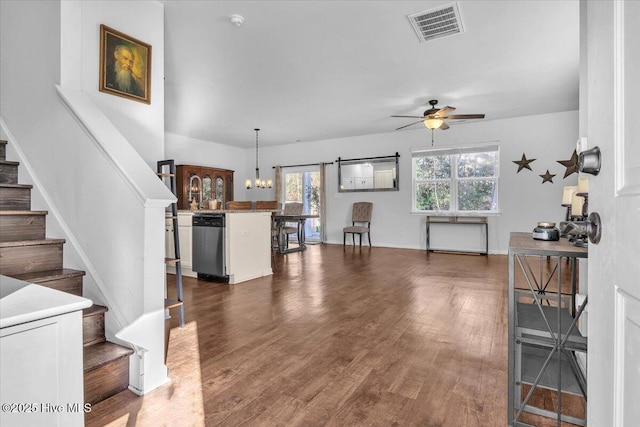 living area featuring dark wood-style flooring, stairway, visible vents, and a ceiling fan