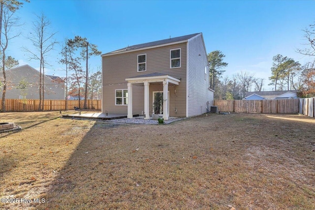 rear view of house featuring a yard, a fenced backyard, a patio area, and cooling unit