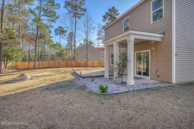 view of yard with an outdoor fire pit, a patio, and fence