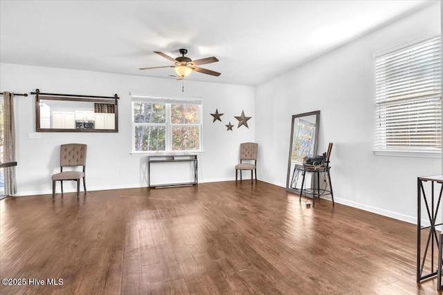 unfurnished room with ceiling fan, baseboards, and wood finished floors