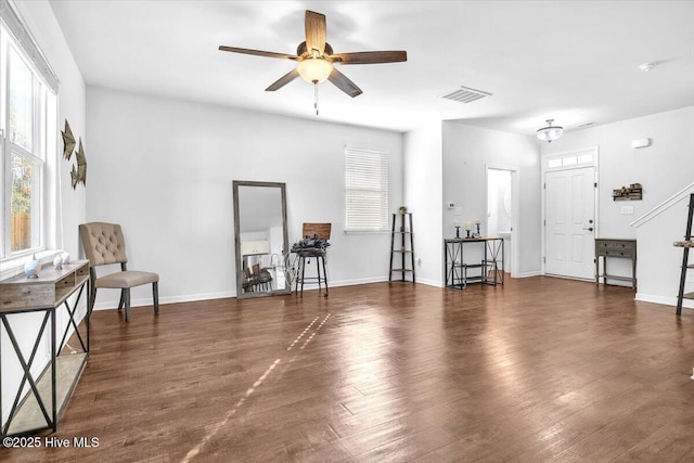 sitting room featuring a ceiling fan, visible vents, baseboards, and wood finished floors