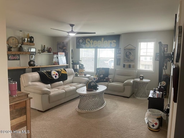 carpeted living room featuring ceiling fan