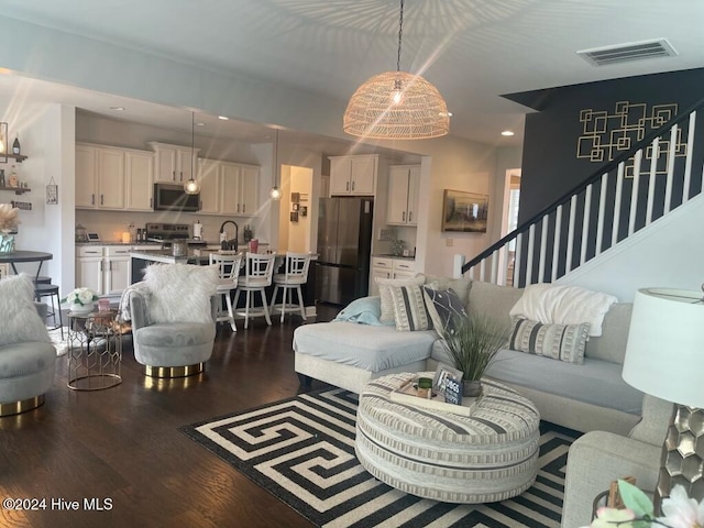 living room featuring hardwood / wood-style flooring and sink