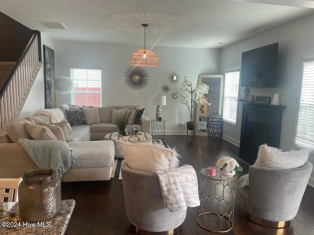 living room featuring plenty of natural light and dark hardwood / wood-style floors