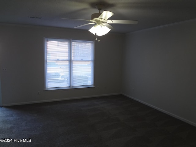 carpeted empty room featuring ceiling fan and crown molding