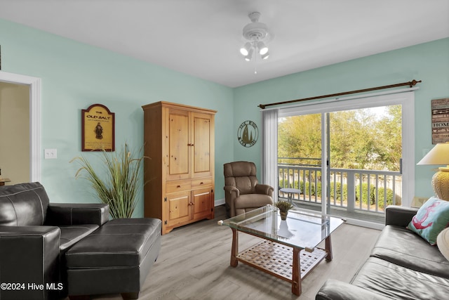 living room with ceiling fan and light hardwood / wood-style flooring