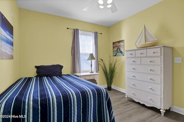 bedroom with ceiling fan and light wood-type flooring