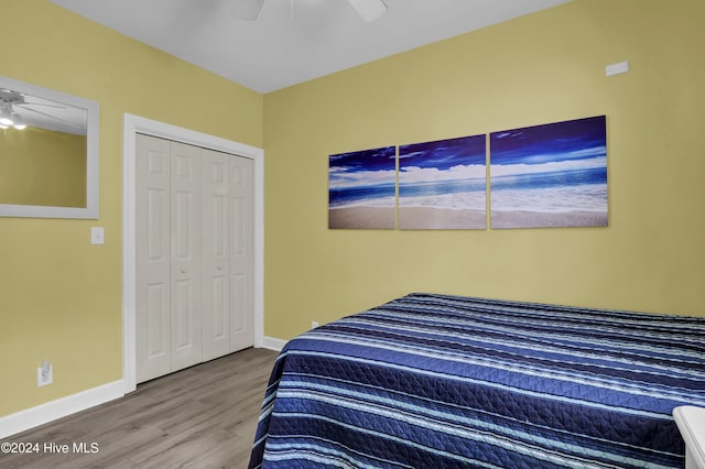 bedroom featuring ceiling fan, a closet, and hardwood / wood-style floors