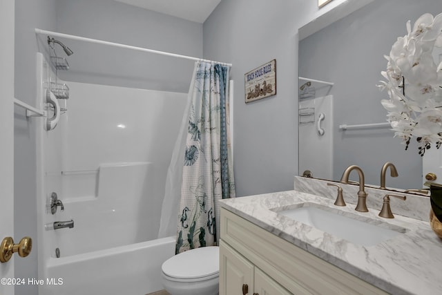 full bathroom featuring toilet, vanity, and shower / tub combo with curtain