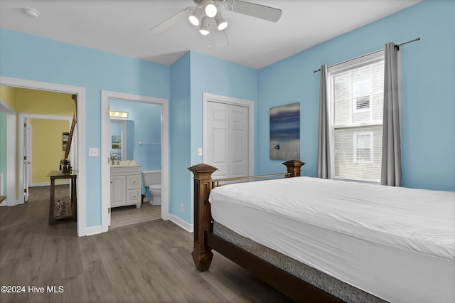 bedroom with ceiling fan, wood-type flooring, ensuite bathroom, and a closet