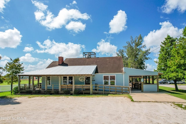 view of front facade with covered porch and a carport