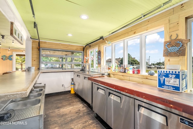 kitchen featuring dark hardwood / wood-style flooring, butcher block countertops, and sink