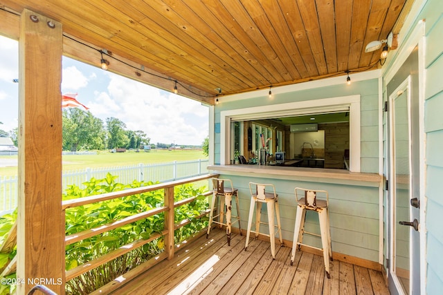 wooden terrace featuring an AC wall unit