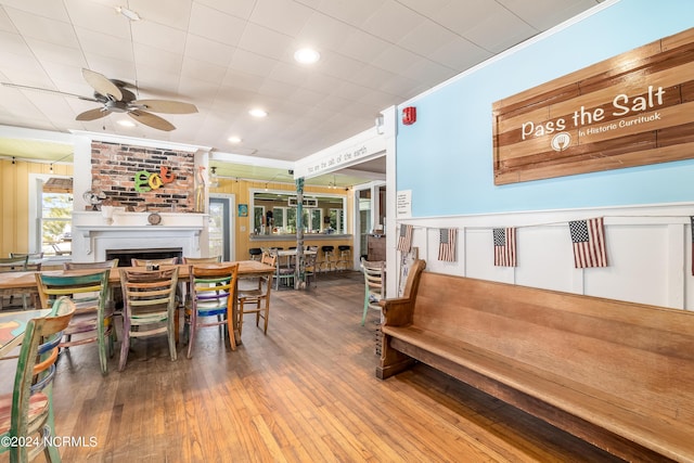 dining area with ceiling fan, crown molding, and wood-type flooring