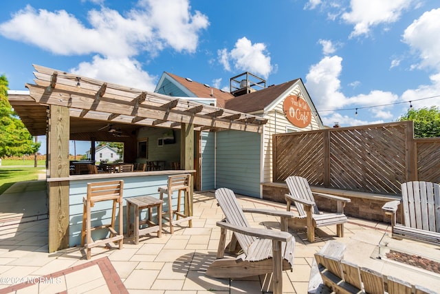 view of patio / terrace with a pergola, ceiling fan, and an outdoor bar