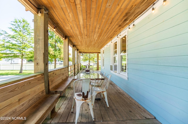 wooden terrace featuring covered porch