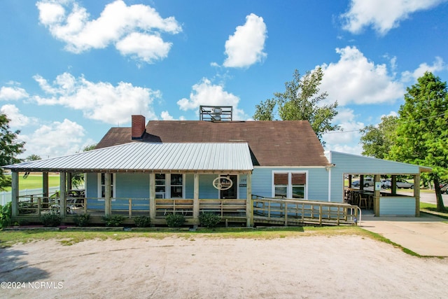 view of front of house with a carport and covered porch