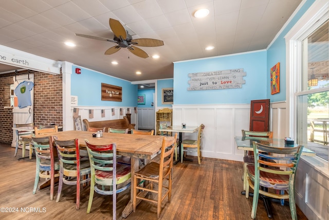 dining area with dark hardwood / wood-style floors, ceiling fan, and crown molding