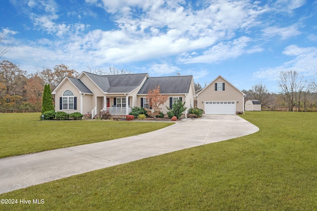 ranch-style home featuring a porch, an outdoor structure, and a front yard