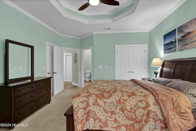 bedroom with light carpet, a tray ceiling, ceiling fan, and ornamental molding