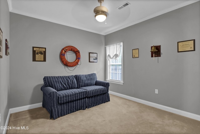 sitting room featuring carpet floors, ceiling fan, and ornamental molding