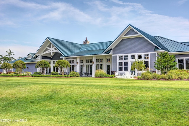 rear view of property featuring a yard