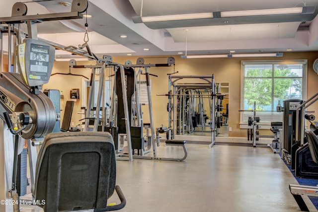 workout area with a raised ceiling