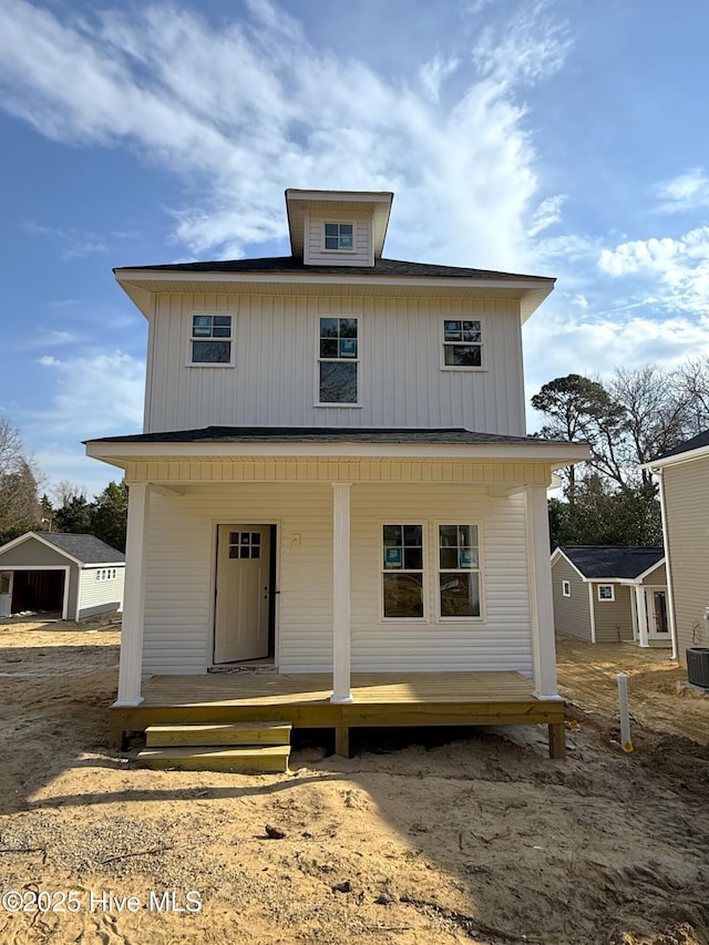 rear view of house featuring central AC and a porch