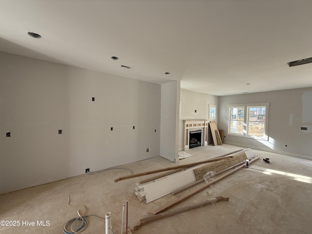 unfurnished living room with a fireplace and visible vents