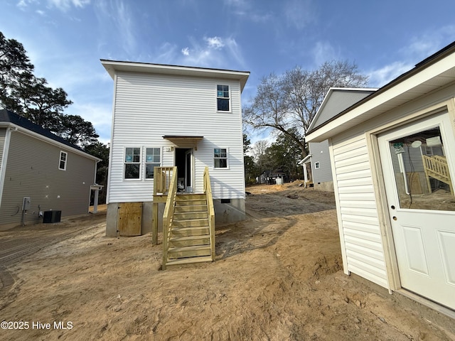 back of house with crawl space and central AC