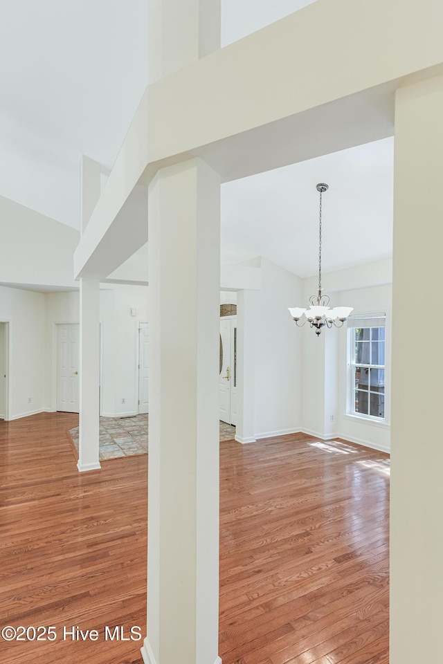 3882 White Blossom Cir, Southport, NC 28461 - interior space with a chandelier, light wood finished floors, and baseboards
