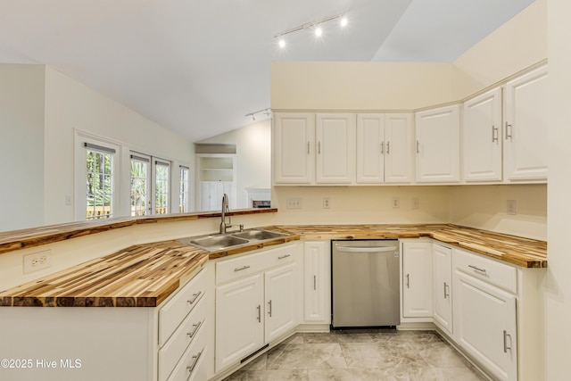 3882 White Blossom Cir, Southport, NC 28461 - kitchen with rail lighting, a peninsula, wooden counters, lofted ceiling, and a sink