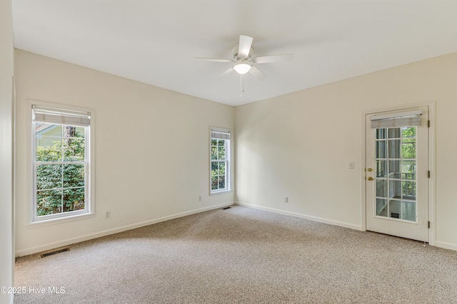 3882 White Blossom Cir, Southport, NC 28461 - spare room featuring visible vents, baseboards, a ceiling fan, and carpet flooring