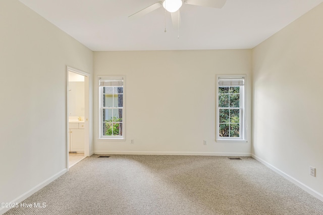3882 White Blossom Cir, Southport, NC 28461 - empty room with light carpet, ceiling fan, baseboards, and visible vents