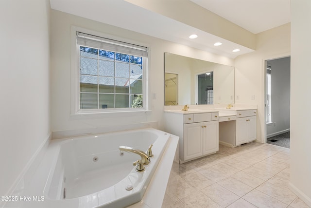 3882 White Blossom Cir, Southport, NC 28461 - bathroom featuring baseboards, recessed lighting, a jetted tub, vanity, and tile patterned flooring