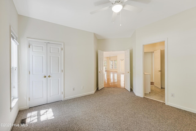 3882 White Blossom Cir, Southport, NC 28461 - unfurnished bedroom with a closet, ceiling fan, baseboards, and carpet
