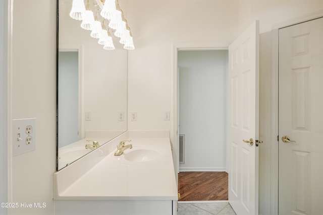 3882 White Blossom Cir, Southport, NC 28461 - bathroom featuring visible vents, an inviting chandelier, and vanity