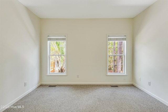 3882 White Blossom Cir, Southport, NC 28461 - carpeted empty room with visible vents, baseboards, and plenty of natural light