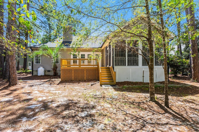 3882 White Blossom Cir, Southport, NC 28461 - rear view of property featuring stairs, a deck, crawl space, and a sunroom