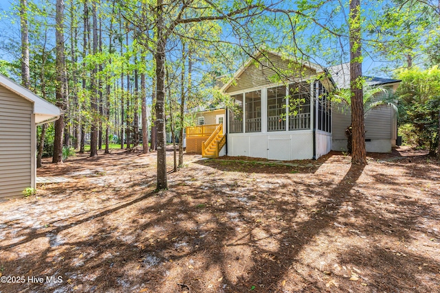 3882 White Blossom Cir, Southport, NC 28461 - view of yard with stairway and a sunroom