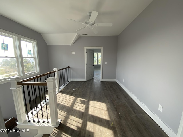 interior space featuring dark hardwood / wood-style floors, ceiling fan, a wealth of natural light, and vaulted ceiling