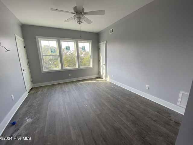 spare room with dark hardwood / wood-style floors and ceiling fan