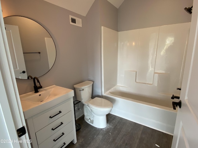 full bathroom featuring hardwood / wood-style floors, vanity, bathtub / shower combination, and toilet