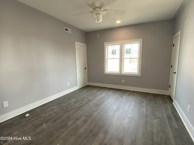 unfurnished room featuring dark hardwood / wood-style flooring and ceiling fan