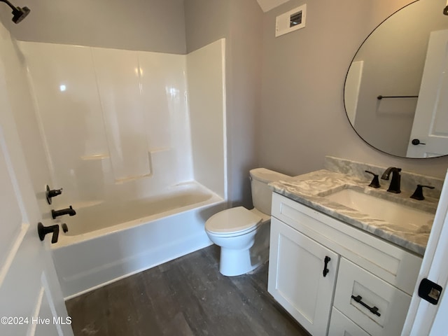 full bathroom featuring vanity, toilet, wood-type flooring, and shower / bath combination