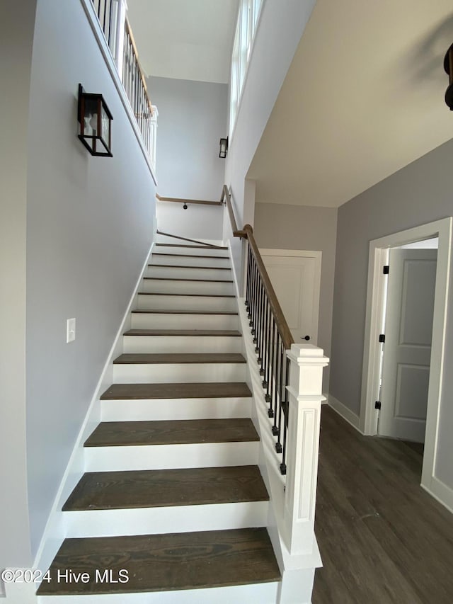 staircase with hardwood / wood-style flooring